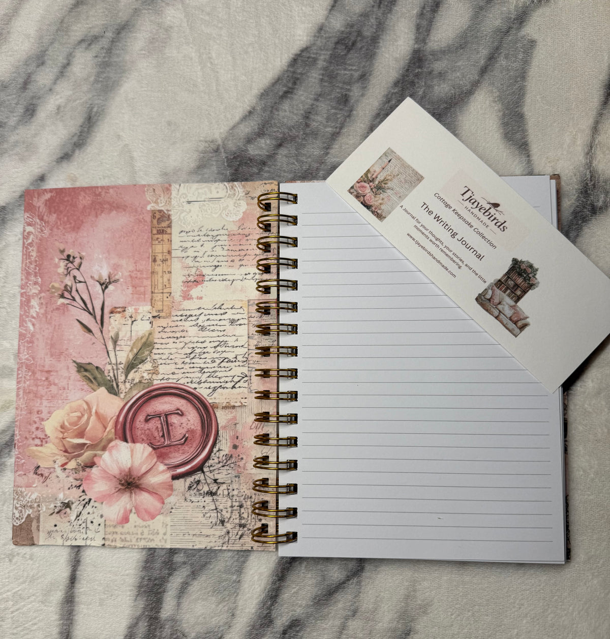 Open journal with product card: Open Cottagecore Collage Journal with a floral inside cover, lined pages, and a product information card.