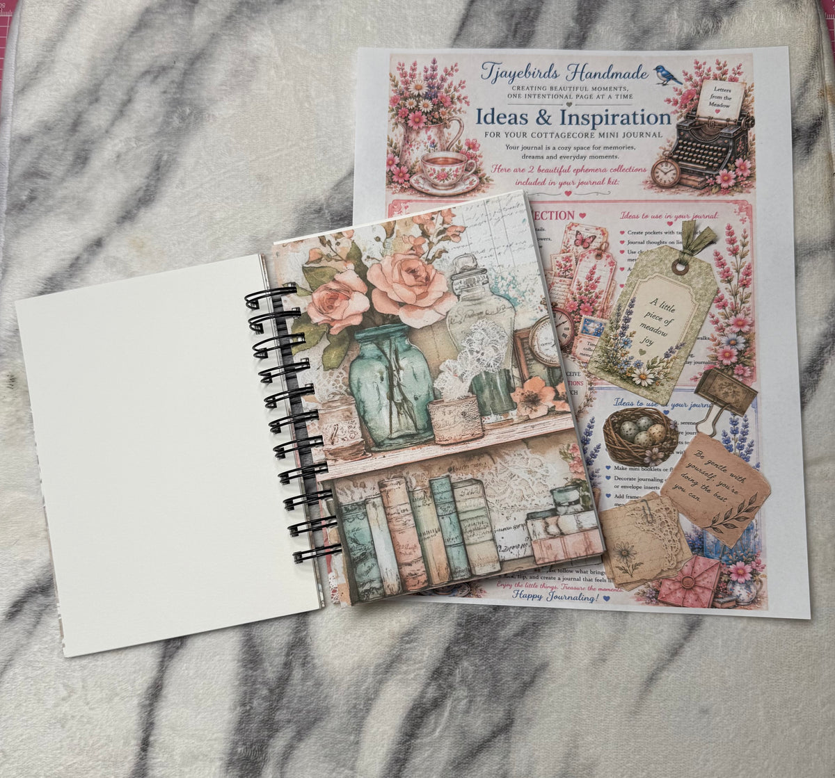 Open journal with tags and guide: “Open cottagecore mini junk journal with floral pockets, decorative tags, and an inspiration sheet.”