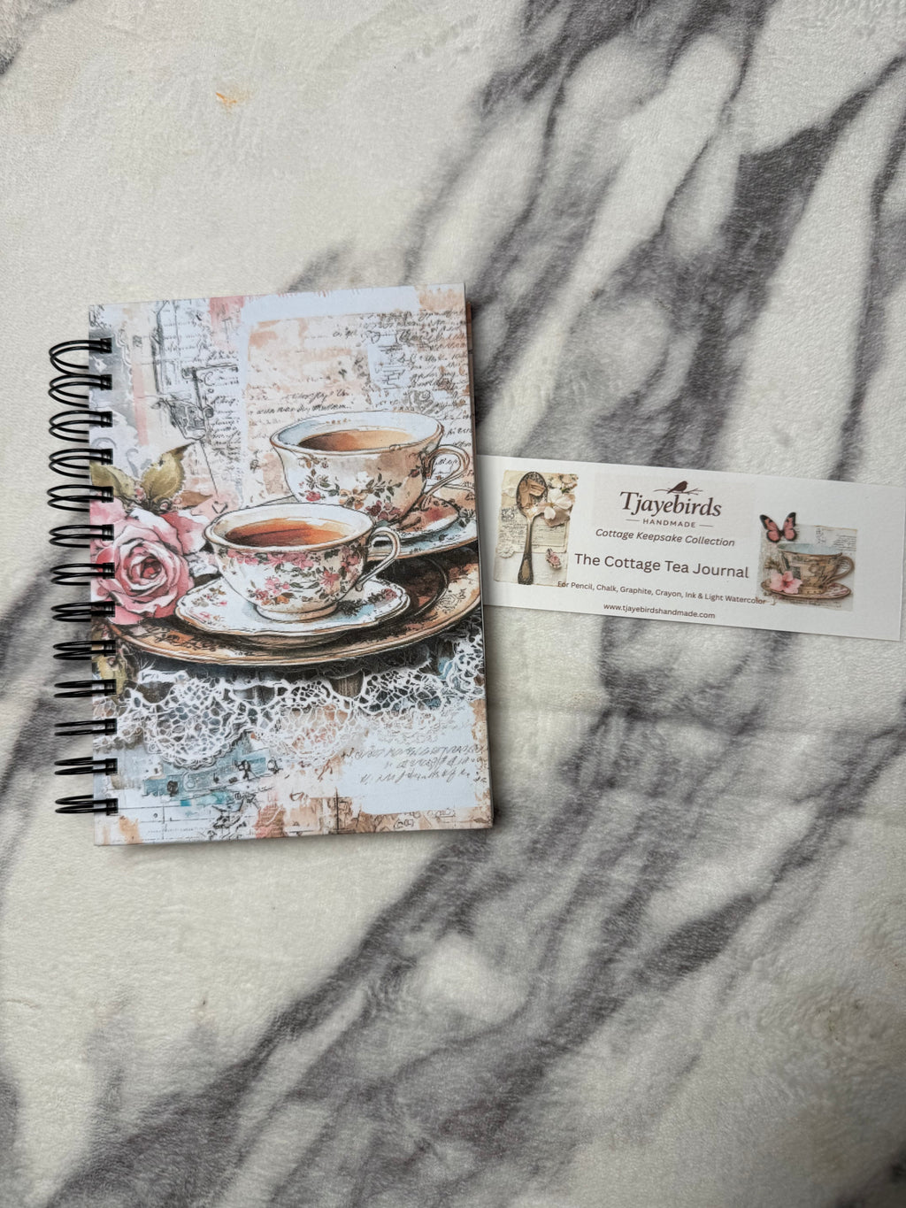 Cover beside the product card: Cottage Tea Time Journal with a vintage teacup and rose cover, black spiral binding, and a product information card.